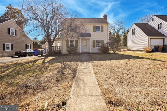 view of front facade featuring a garage, a front lawn, and a chimney