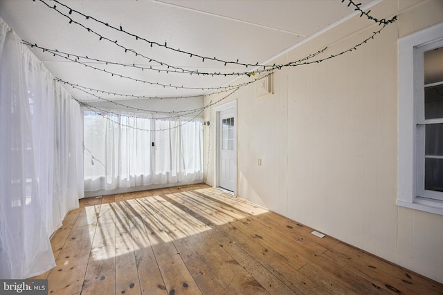 empty room with hardwood / wood-style flooring