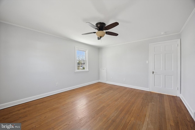 spare room with ceiling fan, baseboards, ornamental molding, and hardwood / wood-style flooring