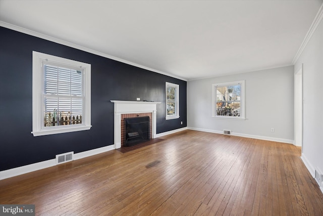 unfurnished living room featuring visible vents, baseboards, and wood-type flooring