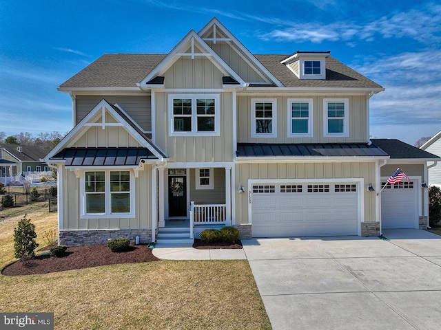 craftsman inspired home with a standing seam roof, driveway, and board and batten siding