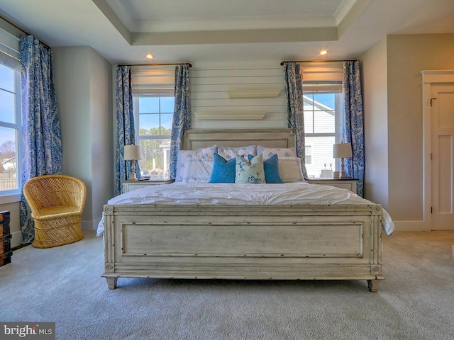 bedroom with crown molding, a raised ceiling, carpet flooring, and recessed lighting