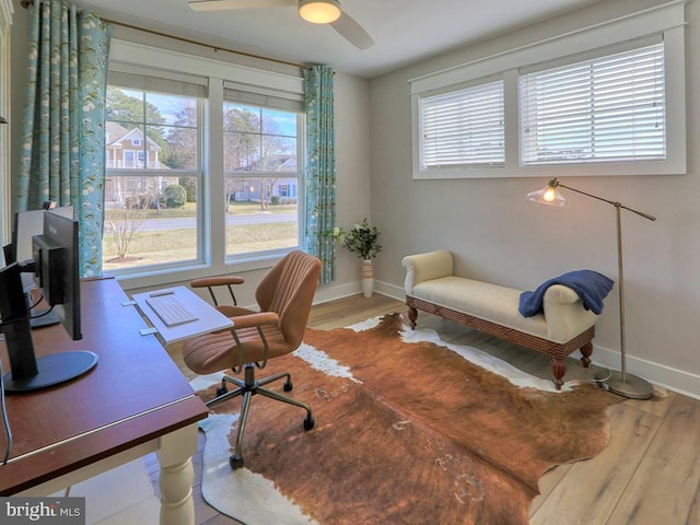 office area featuring baseboards, wood finished floors, and a healthy amount of sunlight