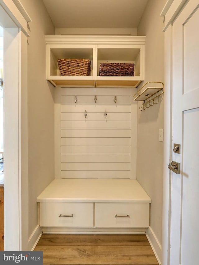 mudroom with wood finished floors and baseboards