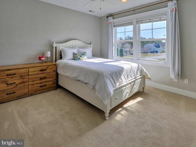 bedroom with light colored carpet, visible vents, and baseboards