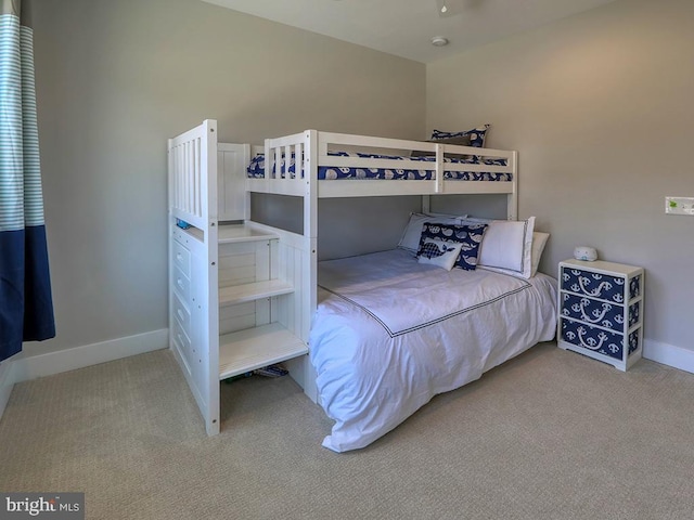 carpeted bedroom featuring baseboards