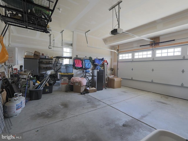 garage with freestanding refrigerator and a garage door opener