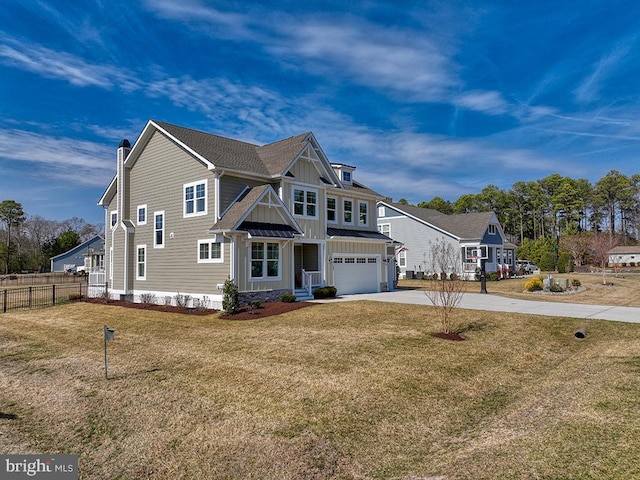 view of front of house featuring an attached garage, board and batten siding, fence, driveway, and a front lawn