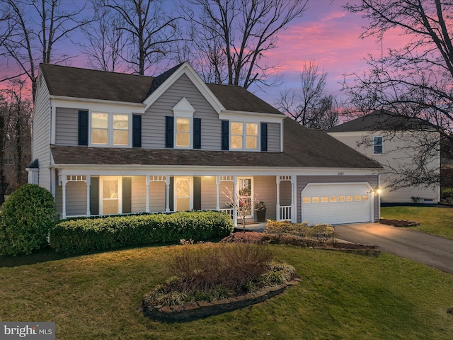 view of front of home with a front lawn, a porch, roof with shingles, concrete driveway, and an attached garage