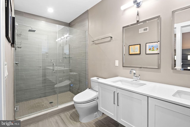 4451 River Ridge Court, Philadelphia, PA 19129 - bathroom with visible vents, a shower stall, toilet, double vanity, and a sink