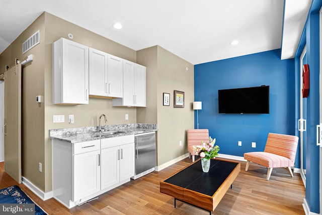 4451 River Ridge Court, Philadelphia, PA 19129 - kitchen with visible vents, white cabinetry, a sink, light wood-style floors, and dishwasher