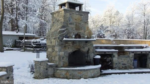 exterior space with an outdoor stone fireplace