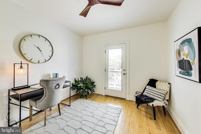 office with hardwood / wood-style flooring, baseboards, and a ceiling fan