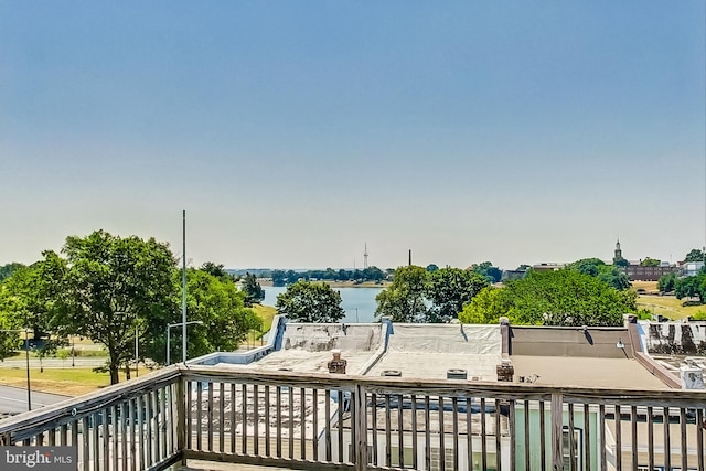 wooden terrace featuring a water view