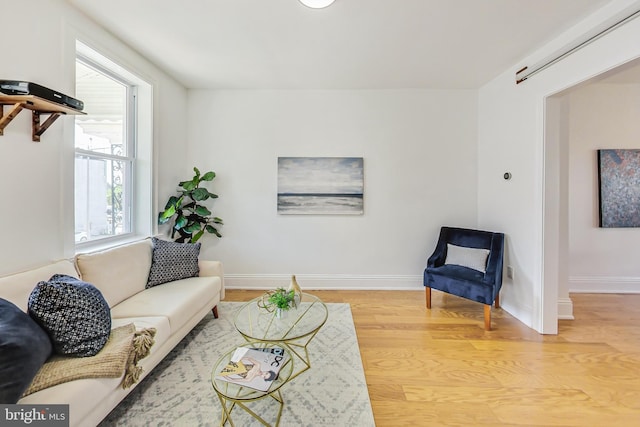 living room with light wood-style flooring and baseboards