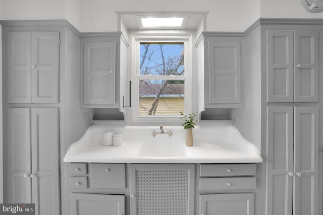 kitchen featuring light countertops and gray cabinetry