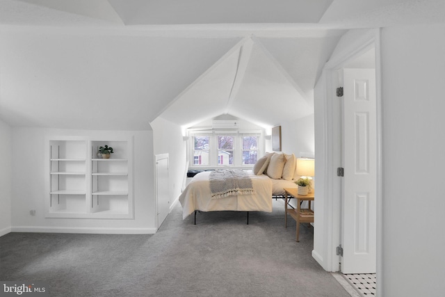 carpeted bedroom featuring baseboards and vaulted ceiling