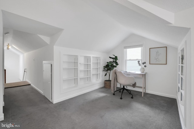 office area with vaulted ceiling, built in shelves, carpet, and baseboards