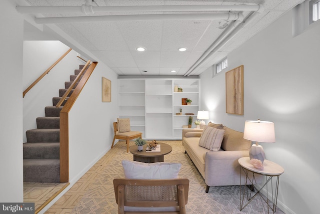 living area featuring stairway, recessed lighting, and baseboards