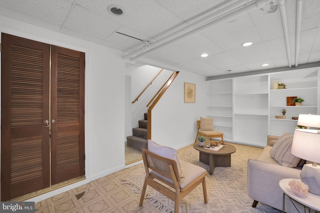 living area with stairway, recessed lighting, and baseboards