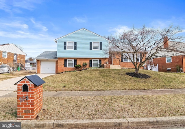 split level home with concrete driveway, brick siding, a front lawn, and an attached garage