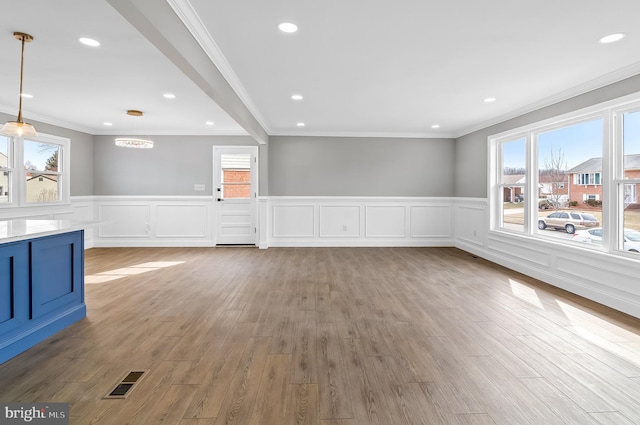 unfurnished living room with ornamental molding, recessed lighting, visible vents, and light wood-style floors