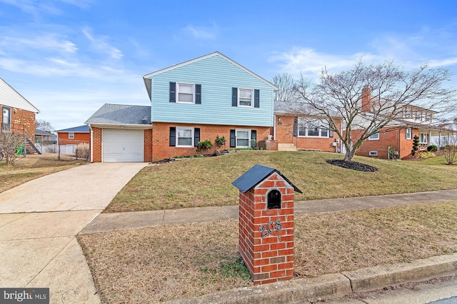 tri-level home with brick siding, driveway, and a front lawn