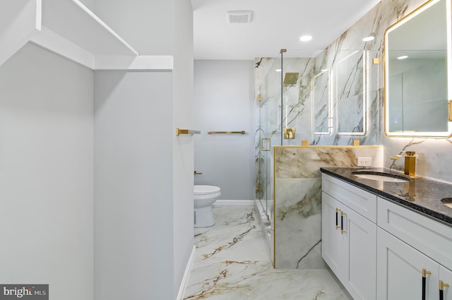 bathroom featuring marble finish floor, vanity, a marble finish shower, and toilet