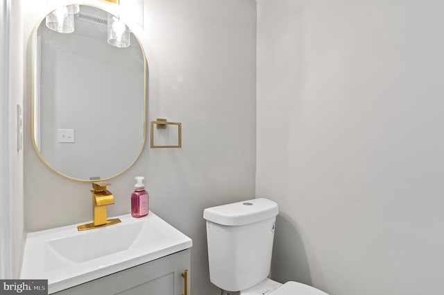 half bath featuring toilet and vanity