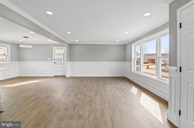 unfurnished room with crown molding, recessed lighting, plenty of natural light, and light wood-style floors