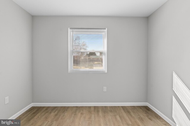 empty room featuring baseboards and wood finished floors