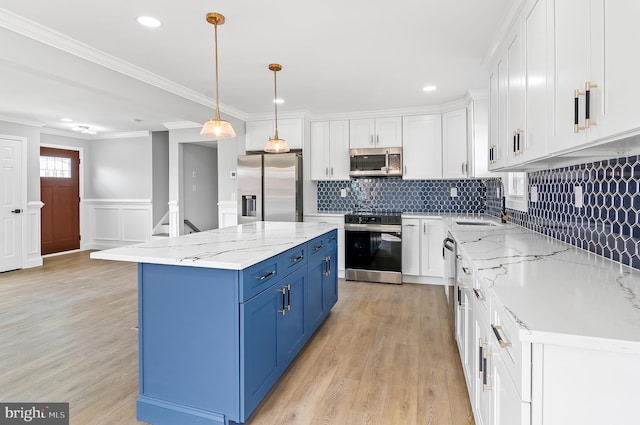 kitchen with stainless steel appliances, white cabinetry, light wood-style flooring, and blue cabinetry