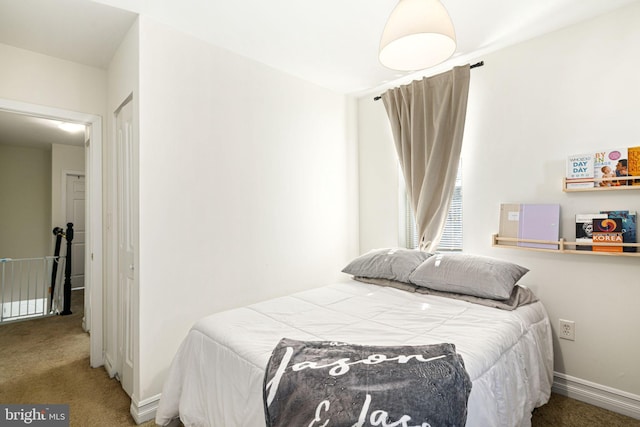 carpeted bedroom featuring baseboards