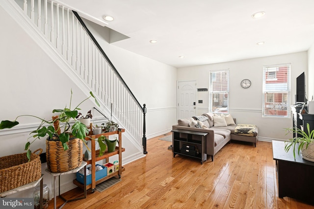 living area featuring recessed lighting, stairway, light wood-style flooring, and baseboards