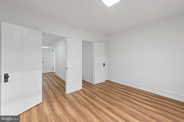 unfurnished bedroom with light wood-style floors and baseboards