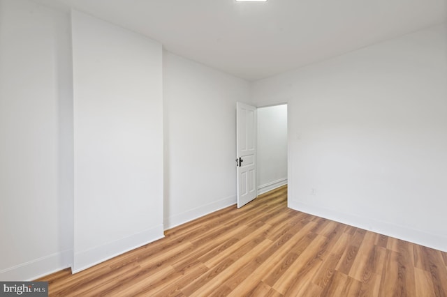 spare room with light wood-style flooring and baseboards