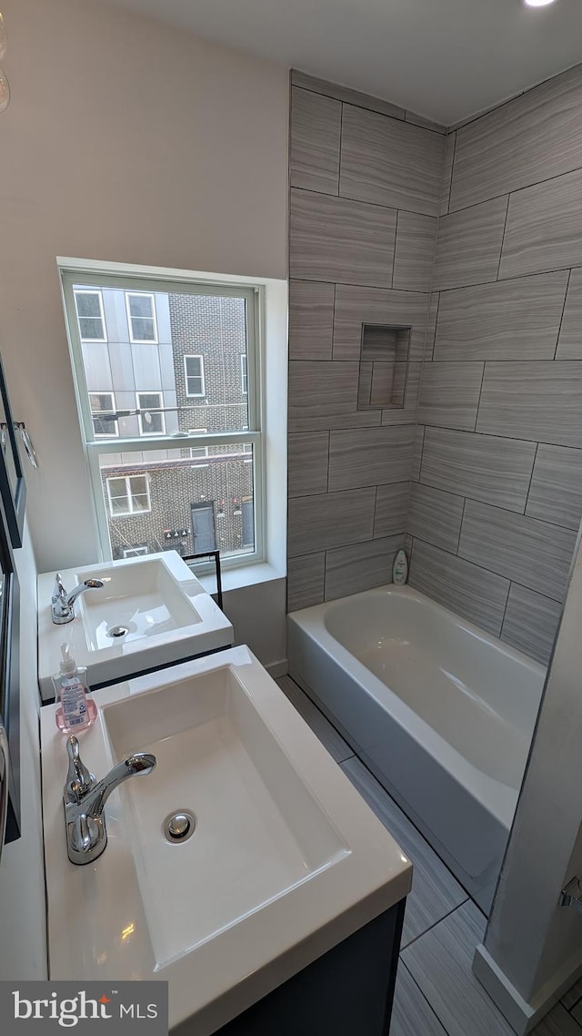 bathroom featuring vanity and a washtub