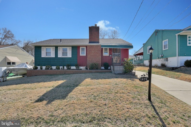 view of front of home with a chimney and a front yard