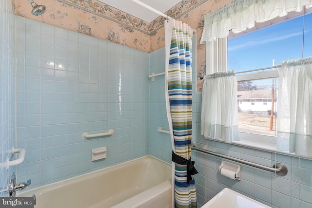 full bathroom with shower / bath combination with curtain and wallpapered walls