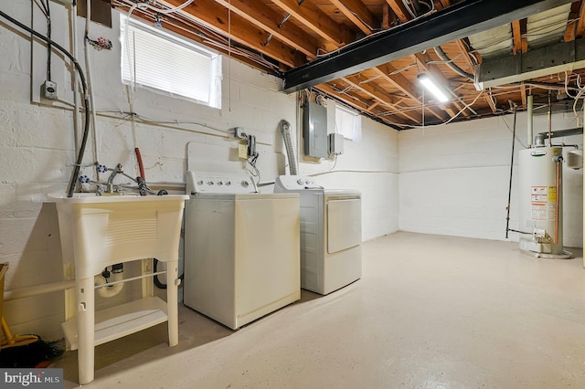 laundry room featuring gas water heater, washing machine and dryer, laundry area, a wealth of natural light, and electric panel