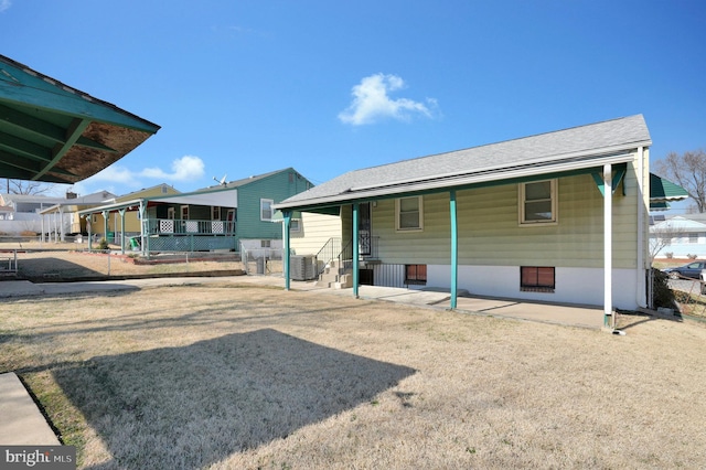 rear view of house with central AC unit