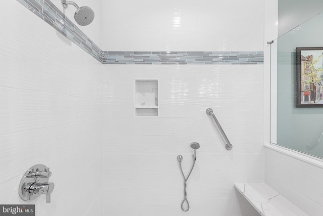 bathroom with a tile shower