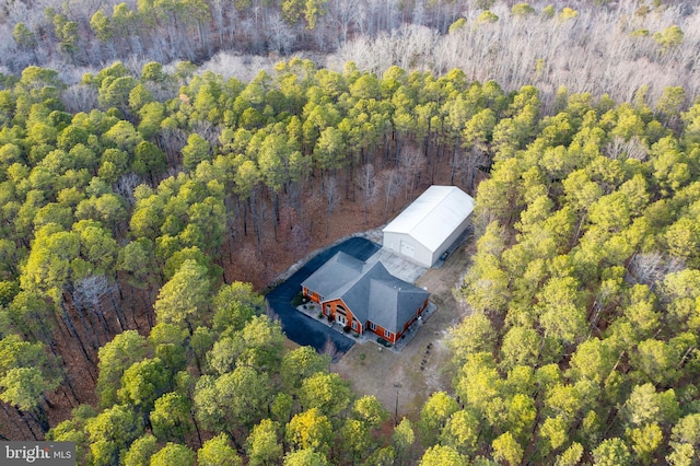 drone / aerial view featuring a wooded view