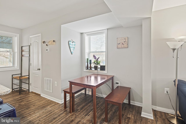 office space featuring visible vents, baseboards, and dark wood-style flooring