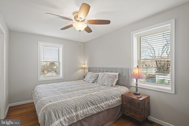 bedroom with a ceiling fan, baseboards, and wood finished floors