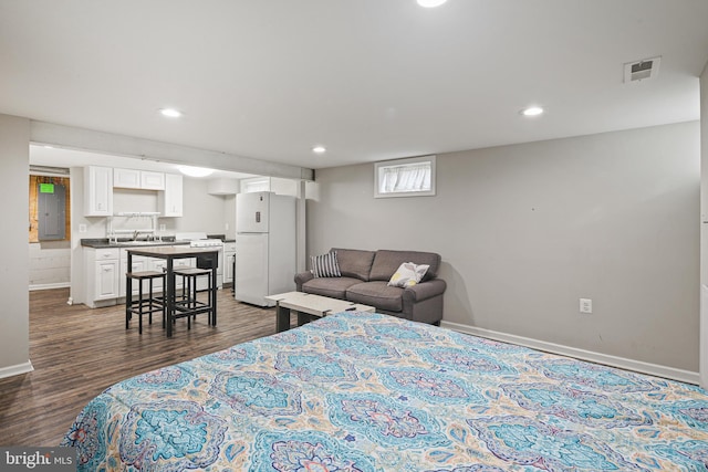 bedroom with visible vents, recessed lighting, freestanding refrigerator, and dark wood-style flooring