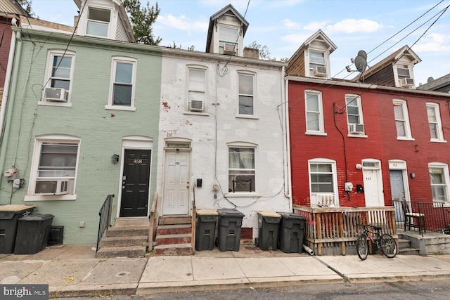 view of property featuring entry steps, cooling unit, and brick siding