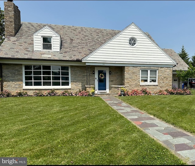 view of front of property with a chimney and a front yard