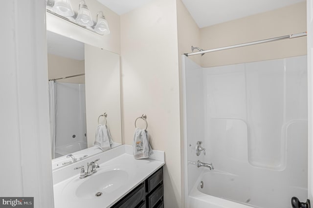 bathroom featuring vanity and washtub / shower combination