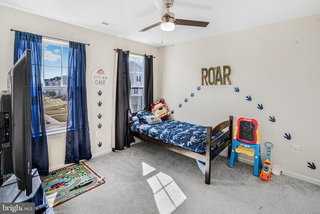 bedroom with visible vents, carpet flooring, a ceiling fan, and baseboards